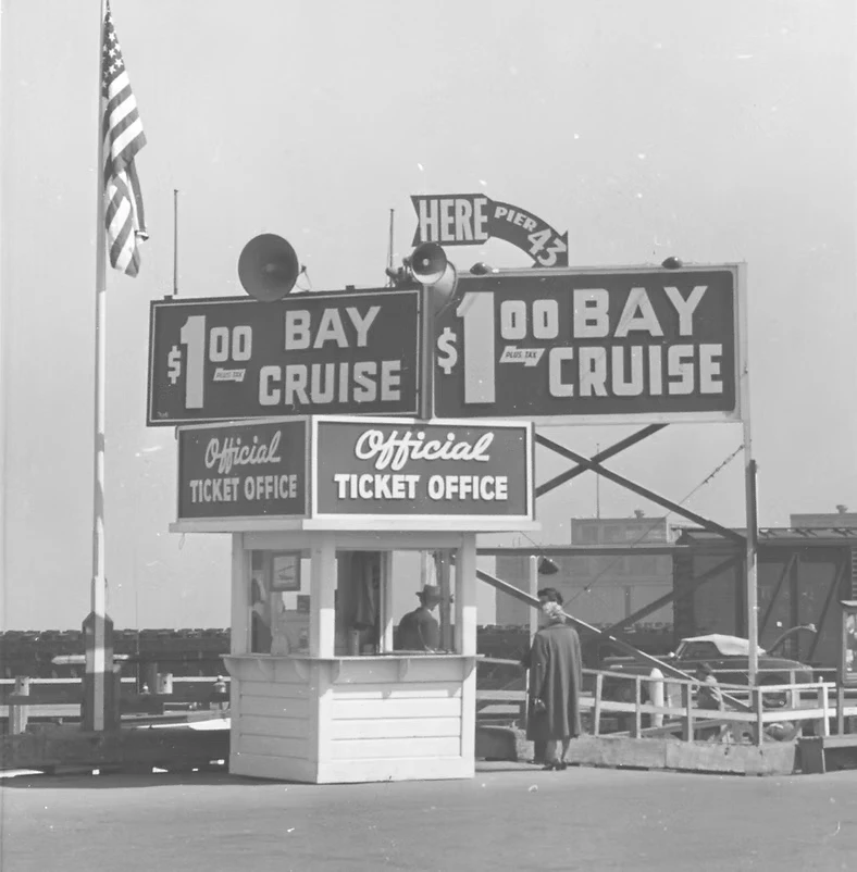 Vintage black and white photo of the Red and White Fleet ticket booth at Pier 43.5 in San Francisco during the 1950s.