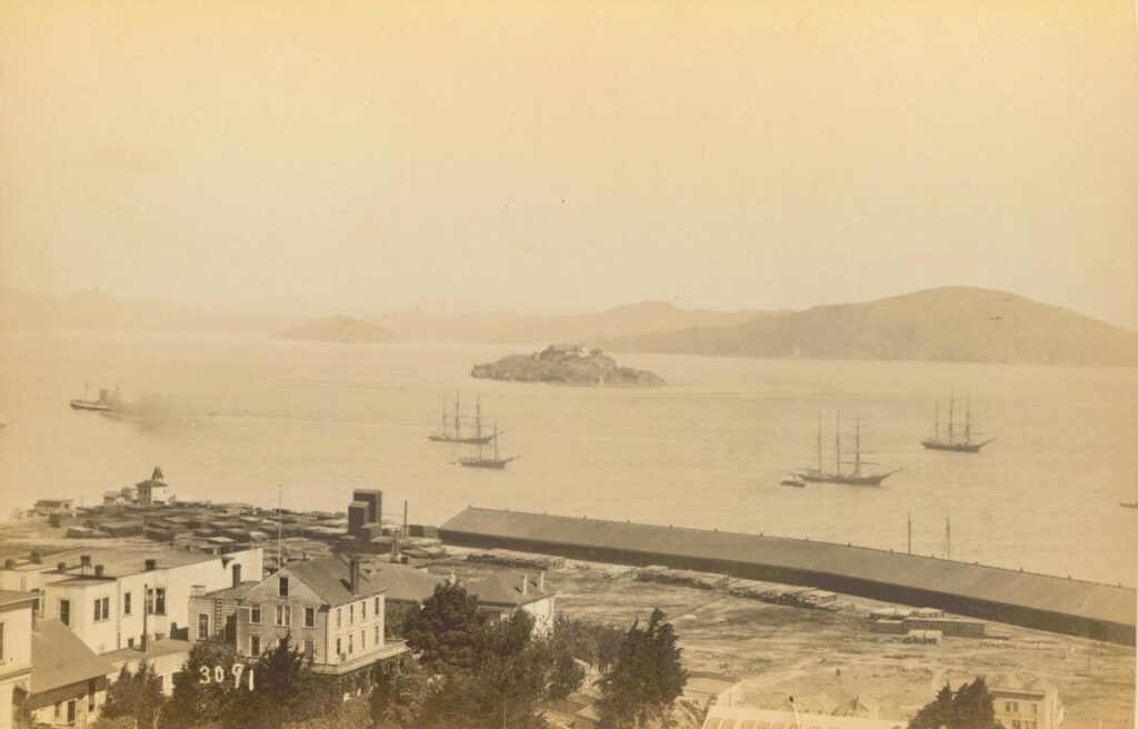 1888 photograph of Alcatraz from Telegraph Hill in the North Beach district of San Francisco. The Citadel stands on top of Alcatraz, with the South Caponier, a defensive brick structure, in the foreground.