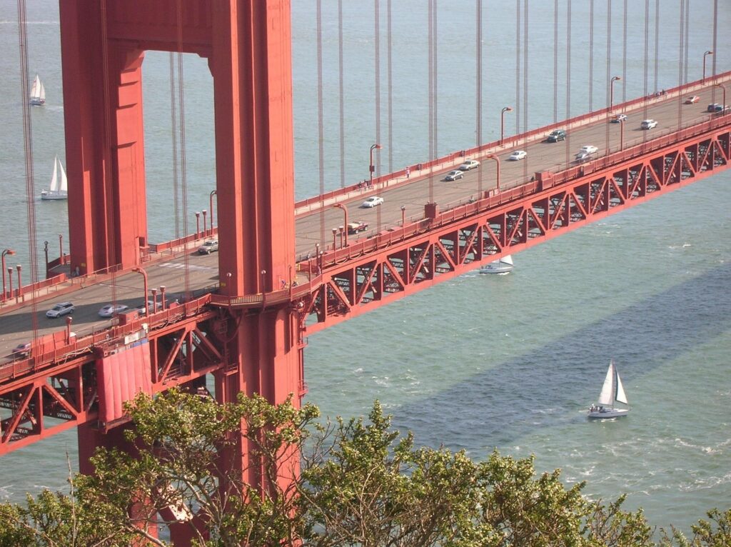 The ultimate guide to the Golden Gate Bridge. Sailboat cruises below the North Tower of the Golden Gate Bridge