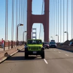 Private group riding in an open-top Jeep on the Golden Gate Bridge during a San Francisco sightseeing tour