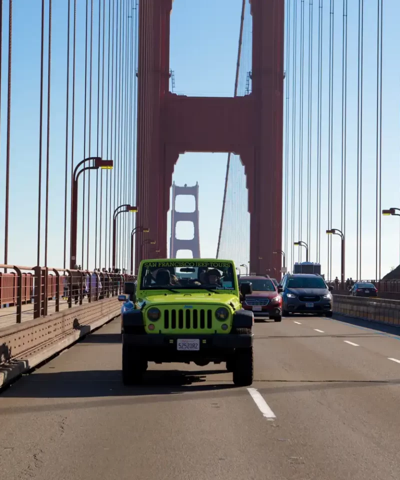 Private group riding in an open-top Jeep on the Golden Gate Bridge during a San Francisco sightseeing tour