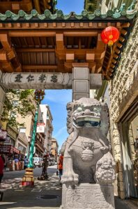 Stone guardian lion statue standing at the Dragon Gate on Grant Street in San Francisco’s Chinatown