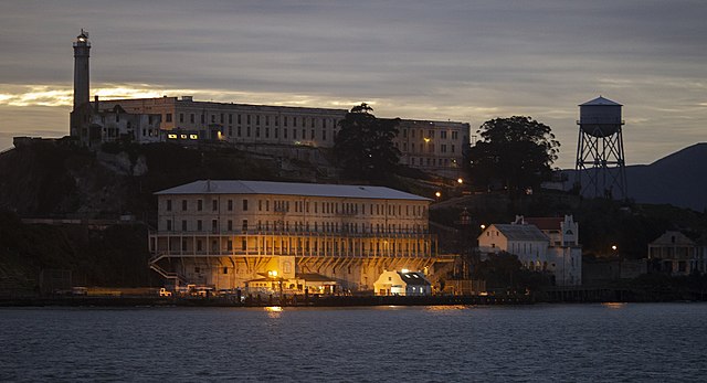 Administration Building on Alcatraz Island viewed from San Francisco Bay at night during an Alcatraz island tour