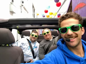 Tour guide Anthony and two guests smiling inside an open-air Jeep at the start of a San Francisco sightseeing tour by the bay