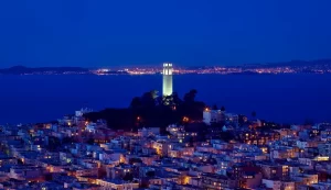 Coit Tower and Telegraph Hill illuminated at night during a San Francisco sunset or city lights Jeep tour