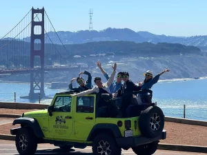 Group photo at the Marin Headlands with the Golden Gate Bridge in the background during a private San Francisco Jeep tour