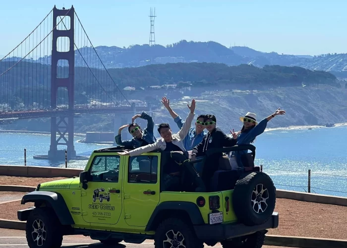 Group photo at the Marin Headlands with the Golden Gate Bridge in the background during a private San Francisco Jeep tour