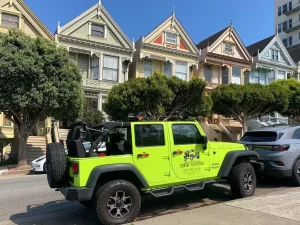 Parked Jeep tour vehicle at Postcard Row in Alamo Square Park, San Francisco