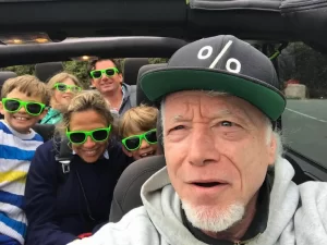 Tour guide Sean and a family group with children taking a selfie inside an open-air Jeep during a San Francisco sightseeing tour