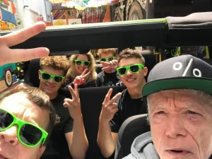 Tour guide Sean and guests taking a selfie inside an open-air Jeep during a San Francisco sightseeing tour