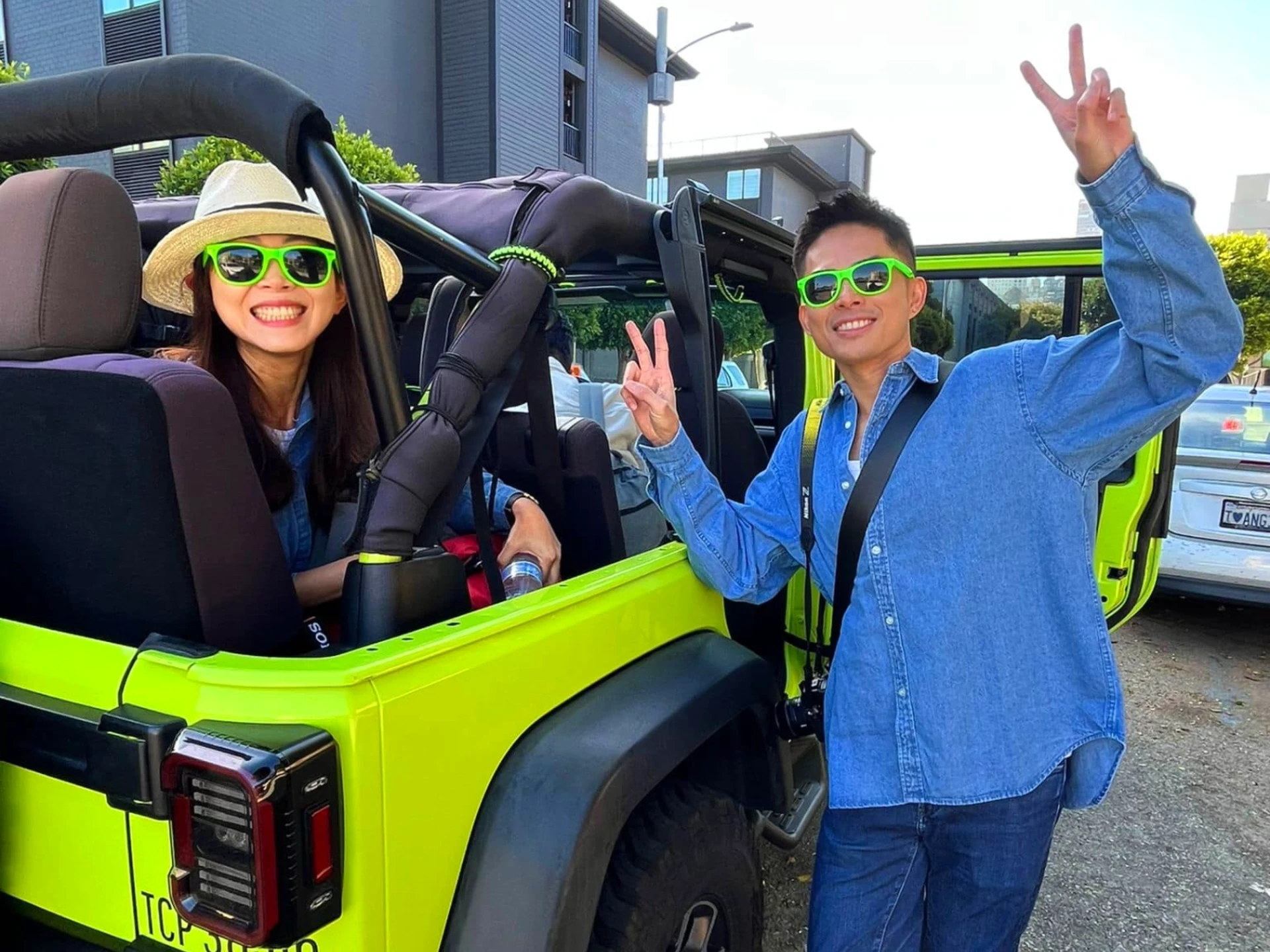 Tour Guests All Smiles Loading Up for a San Francisco Jeep Tour Tour guests smiling as they load into an open-air Jeep at the start of a San Francisco sightseeing tour