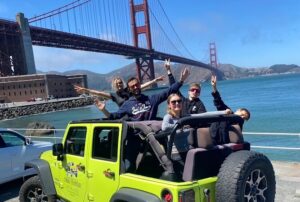 Tour guests at Fort Point on a sunny day with clear views of the Golden Gate Bridge during a San Francisco Jeep sightseeing tour