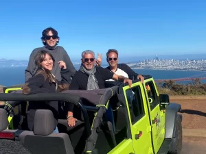 Tour guests riding in an open-air Jeep enjoying views from the Marin Headlands and Hawk Hill during a private San Francisco sightseeing tour