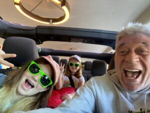 Tour guide Jo-Jo and two guests smiling inside an open-air Jeep before a San Francisco sightseeing tour